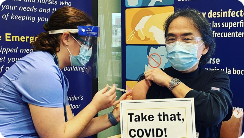 man wearing a mask receiving a vaccine at ebnhc